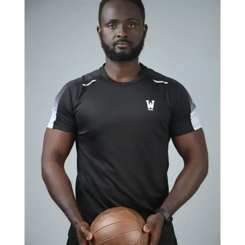 man wearing the eco training t-shirt holding a ball