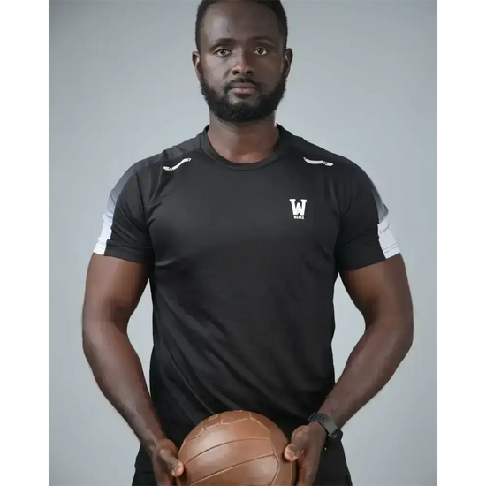 man wearing the eco training t-shirt holding a ball