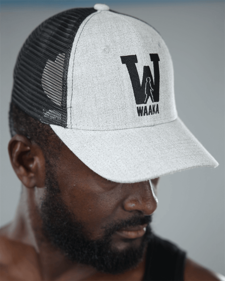 Man wearing a gray and black cap with &