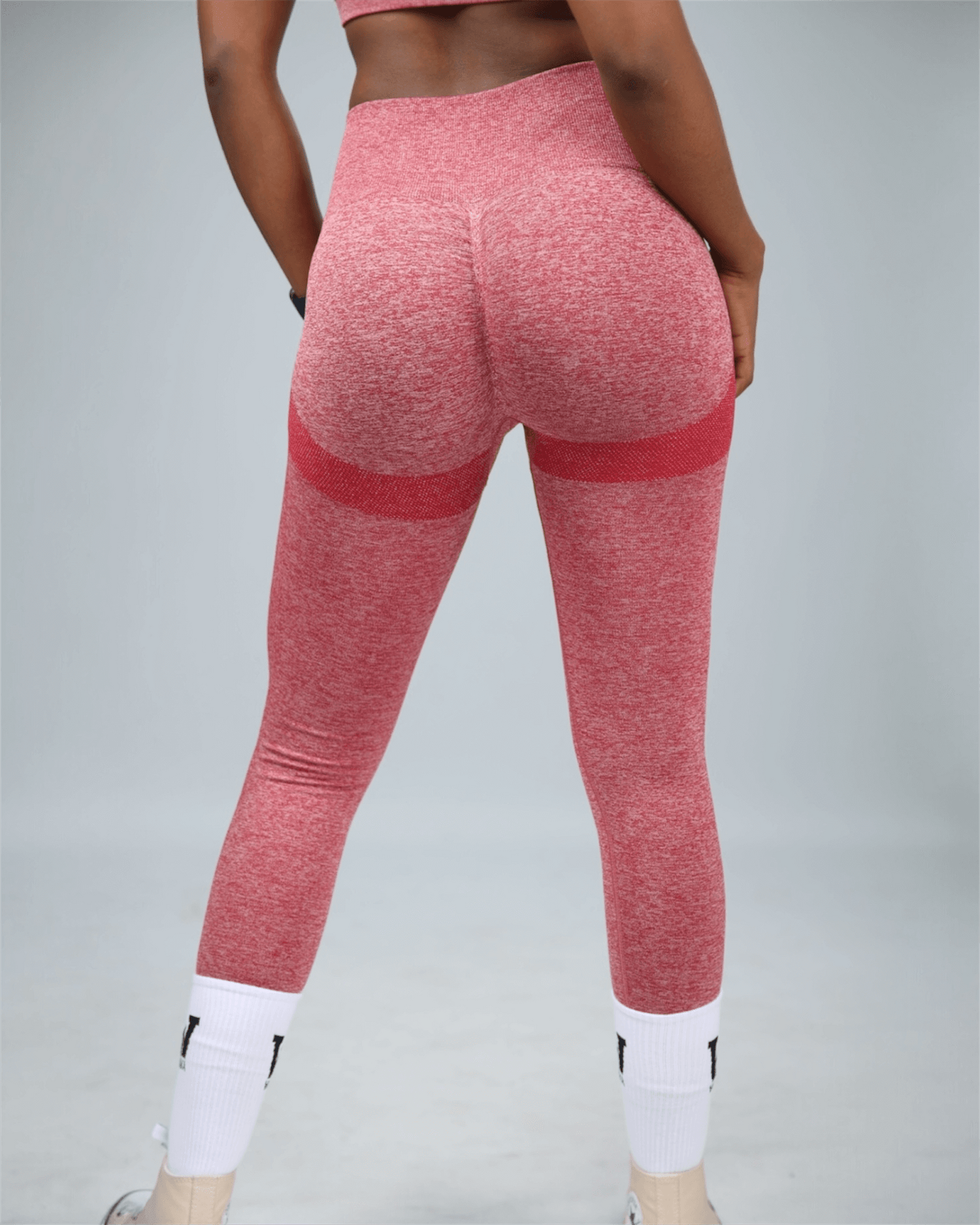 Red leggings with white accents on a gray background