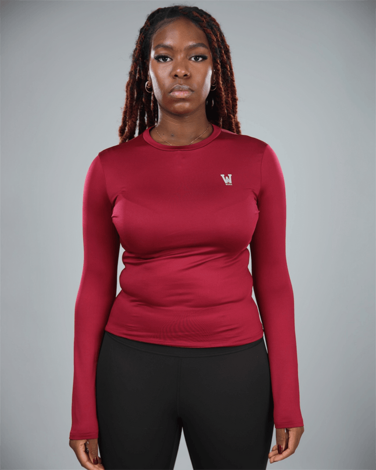 Person wearing a red long-sleeve shirt with a logo on a gray background