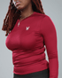 Person wearing a wine red long-sleeve shirt with waaka logo on a grey background