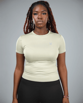 Person wearing a olive green athletic shirt with a logo on a gray background