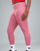 mauve Pink leggings with a logo on a grey background showing side view