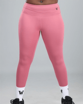 Pink leggings with white socks and black shoes on a gray background