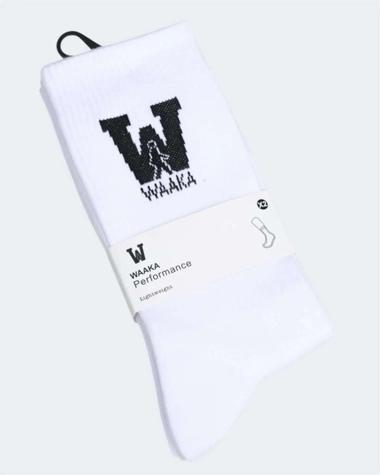 White socks with black waaka logo and text on a white background