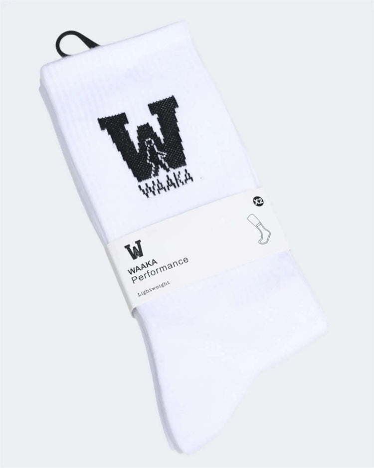 White socks with black waaka logo and text on a white background