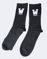 Black sock with WAAKA logo and text on a white background displayed
