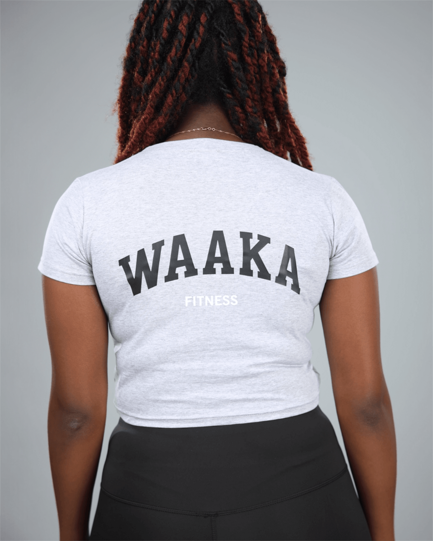 Person wearing a light grey t-shirt with &