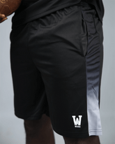Black eco training athletic shorts with a white waaka logo on a grey background