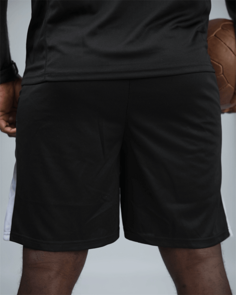 Person wearing black shorts with a blurred background back view