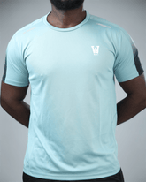 Light blue athletic shirt with waaka logo on a gray background