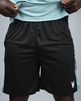 Black eco training shorts with a light blue stripe featuring waaka logo on a grey background front view