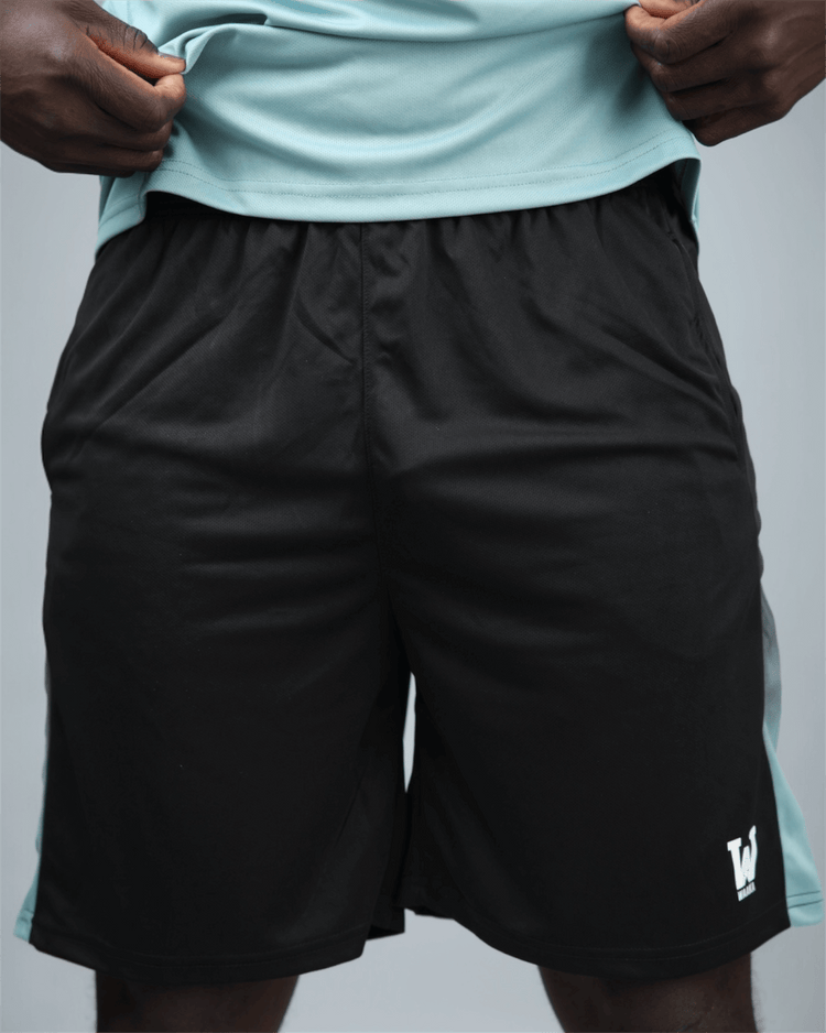 Black eco training shorts with a light blue stripe featuring waaka logo on a grey background front view