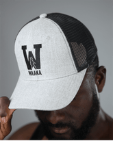 Person wearing a light gray and black mesh cap with &