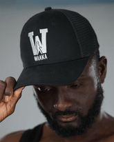 Person wearing a black cap with &