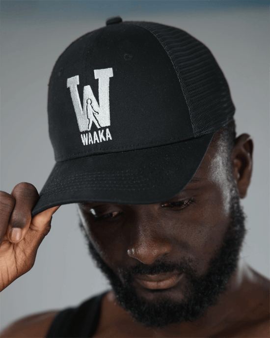 Person wearing a black cap with &