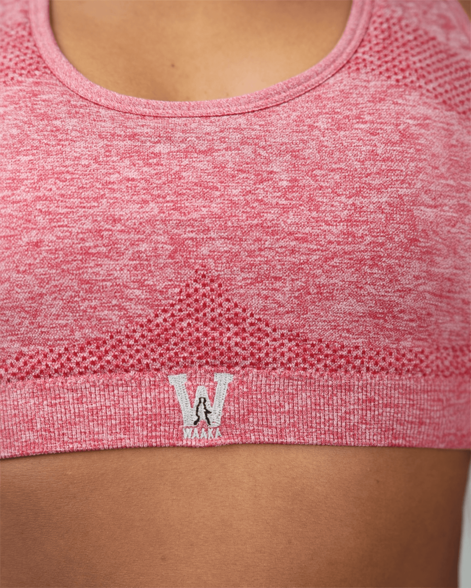 red sports bra with waaka logo on a person wearing it