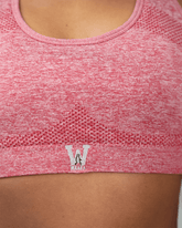 red sports bra with waaka logo on a person wearing it