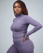 Woman wearing a purple athletic outfit on a gray background