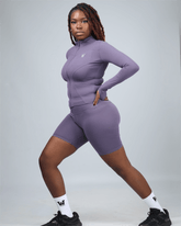 Person wearing purple ignite active shorts on a grey background