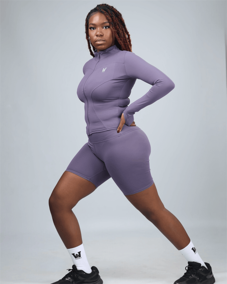 Person wearing purple ignite active shorts on a grey background