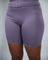 Purple athletic shorts on a plain background
