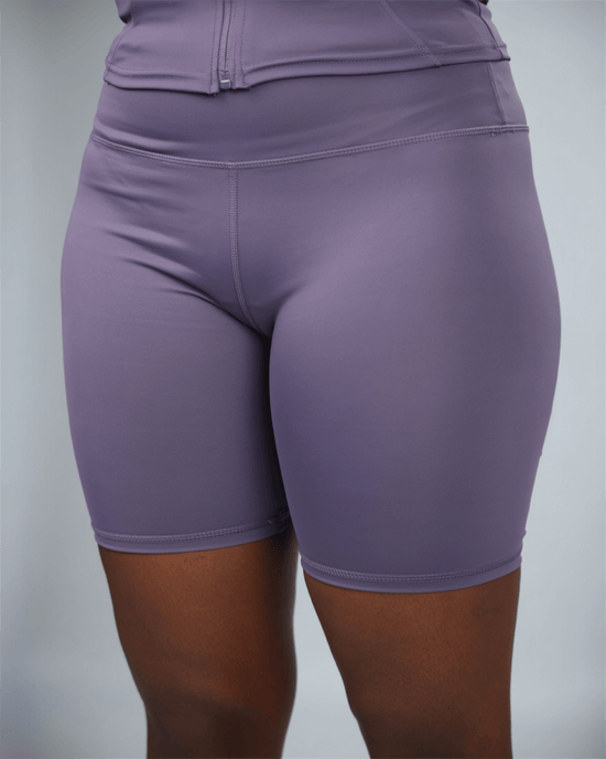 Purple athletic shorts on a plain background