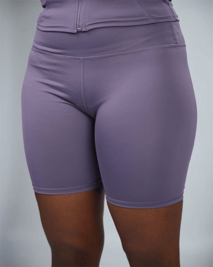 Purple athletic shorts on a plain background